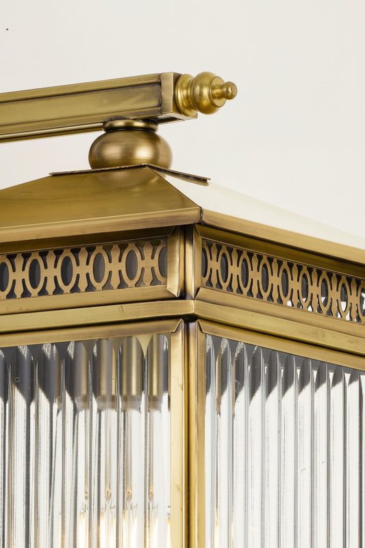 Close up of the small brass wall light with clear fluted glass. 