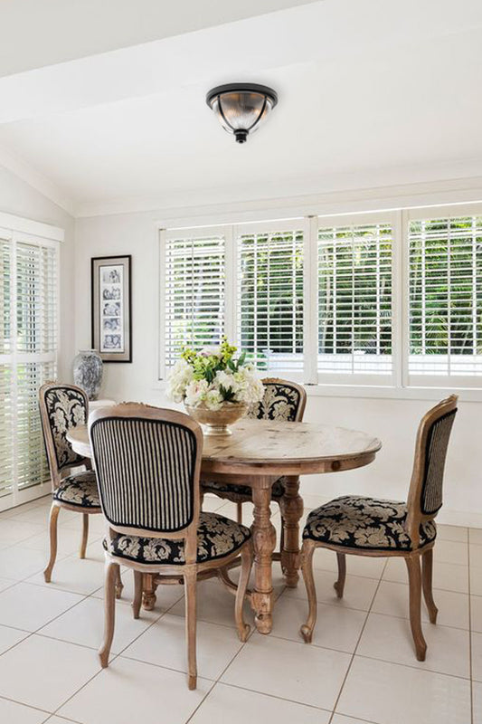 Reeded glass ceiling light with metal banding as a dinig room light