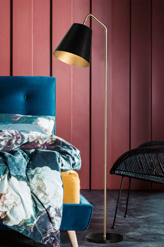 Mid century modern floor lamp in black and gold in a colourful moder bedroom space. 