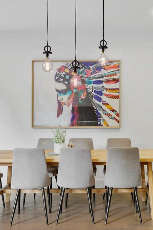 3 Black pendant cord with disc over dining table.