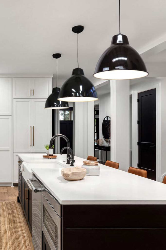 three black pendant lights over kitchen island