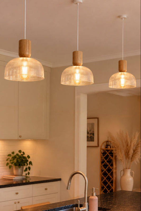 3 Chapman large shades with nord wood timber blocks hanging over a kitchen bench.