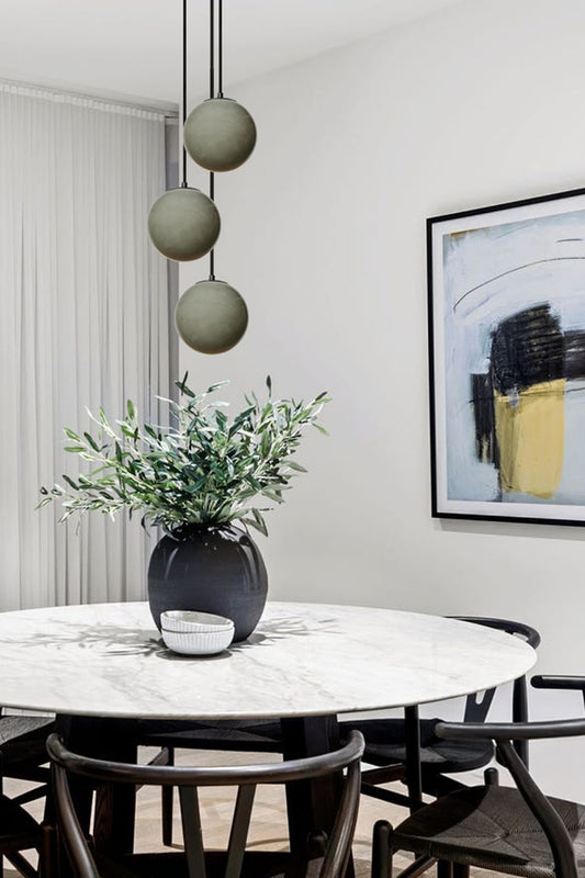Light Grey three drop pendant light over a dining space
