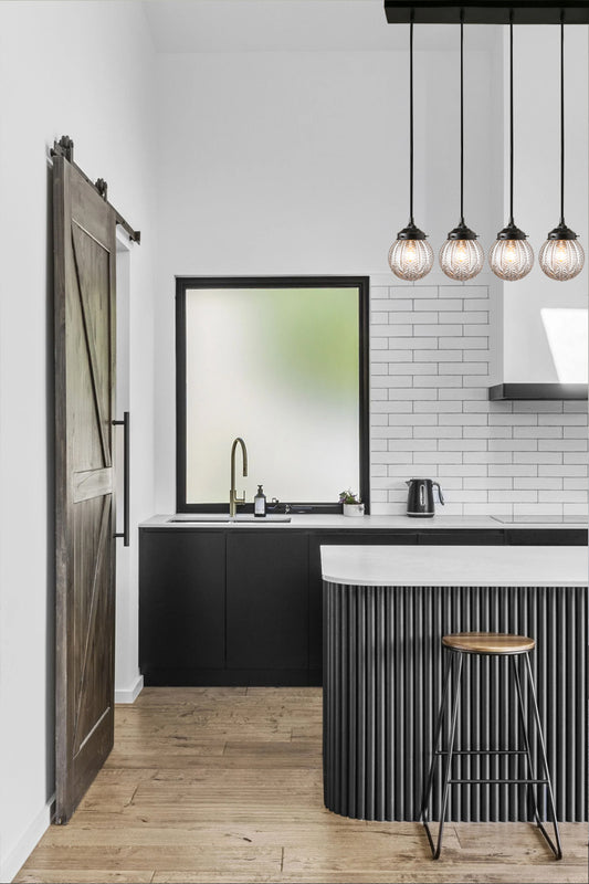 5 light linear light with clear retro textured glass and black fixture in a modern kitchen