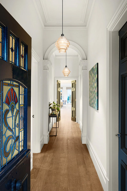 Teo aber tiered glass shades in a traditional hallwaywith modern updates. 