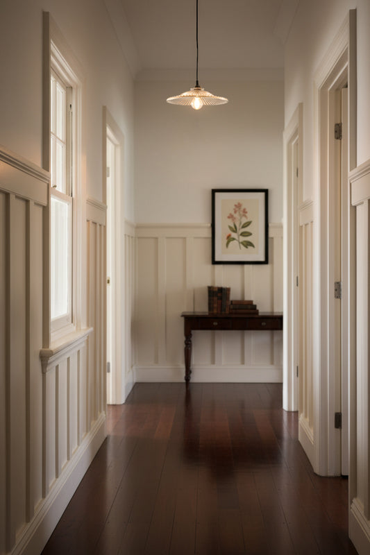 glass pendant light in hallway with floor boards