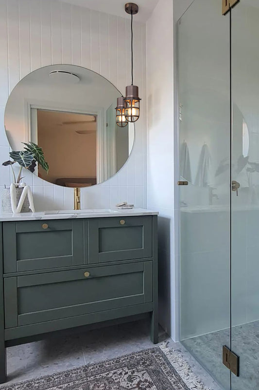 Copper caged pendant light in a fresh bathroom. 