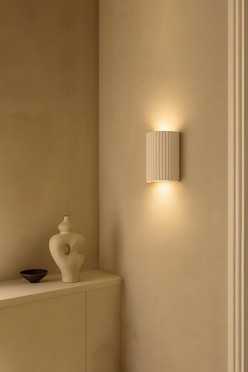 Raynes Plaster Wall Light installed in neutral interior with warm up and down wall lighting