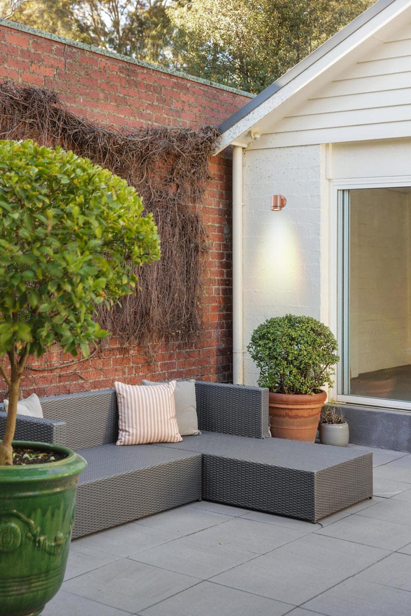 Solid copper spotlight with polished finish in outdoor patio
