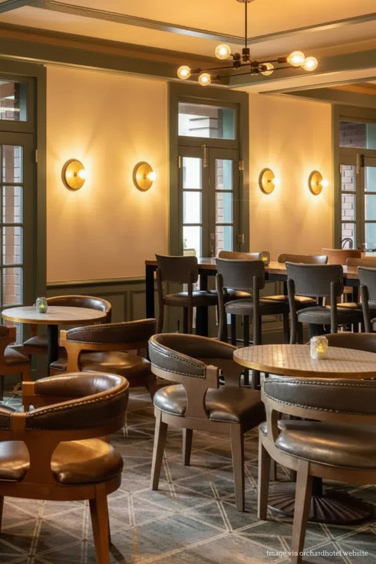 Gold/Brass Disc wall lights installed at the Orchard Hotel. 