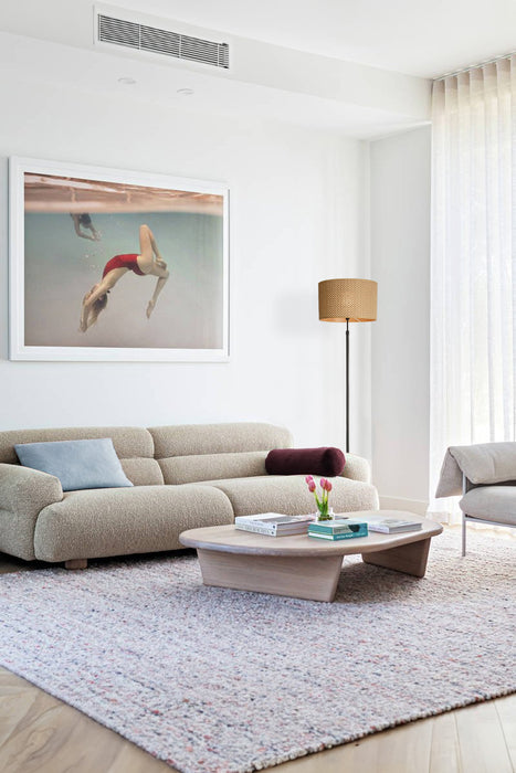 Rope floor lamp next to a sofa in a living room 