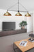 Modern three light brass pendant light in a living room