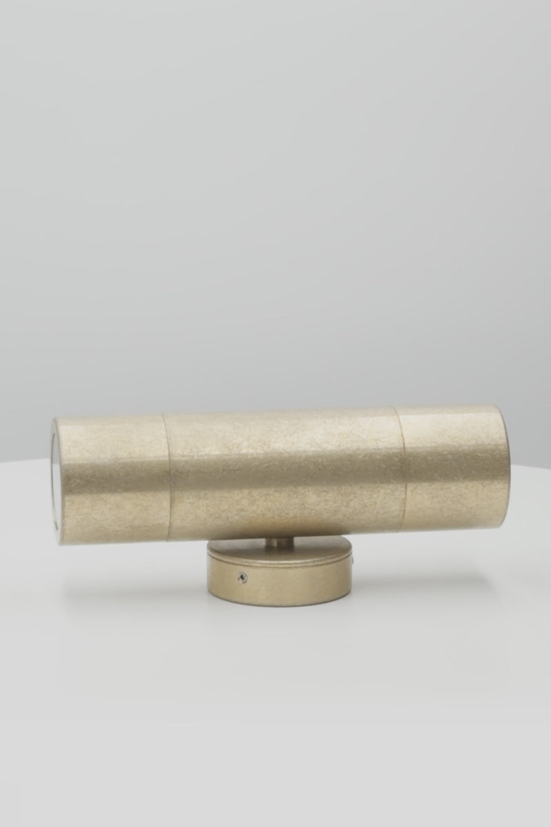 Video showcasing the cylindrical up/down wall light in antique brass. 