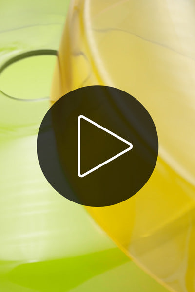 Video of the Valla glass shades in amber and green on a white turntable. 