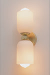 video of wall light showcasing gold brass fittings and two opal glass shades