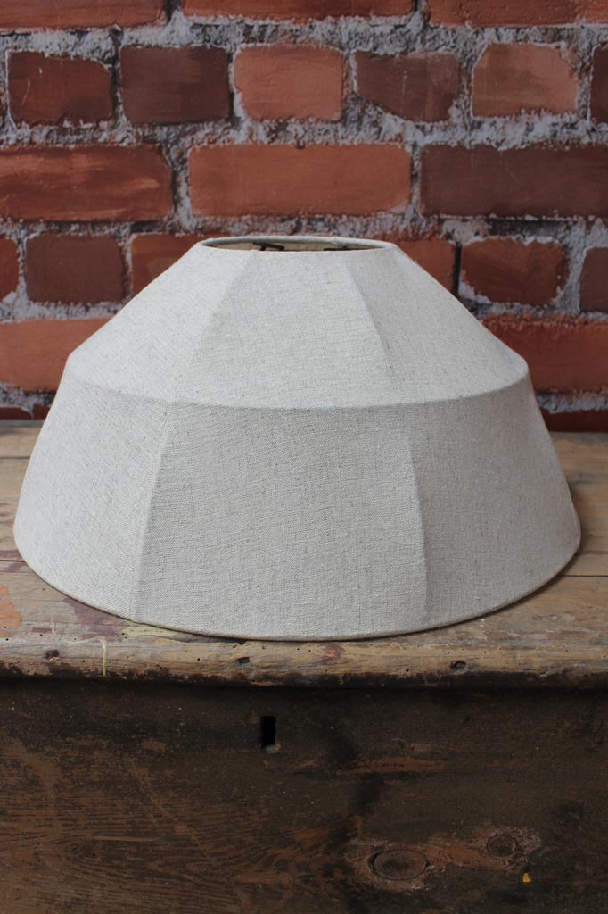 Beige fabric shade on a lack frame, placed on a timber bench. 