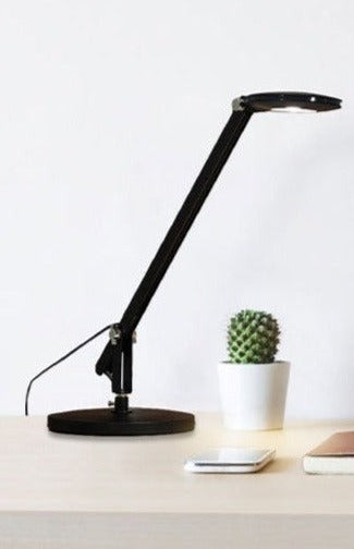 Table lamp in black finish with black cord on a flat surface