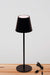 Black LED table lamp over a  table with USB charger