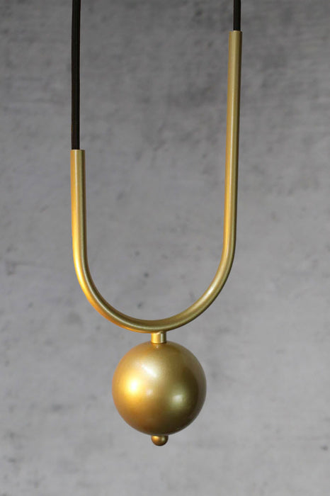 Weighted gold sphere in gold brass finish