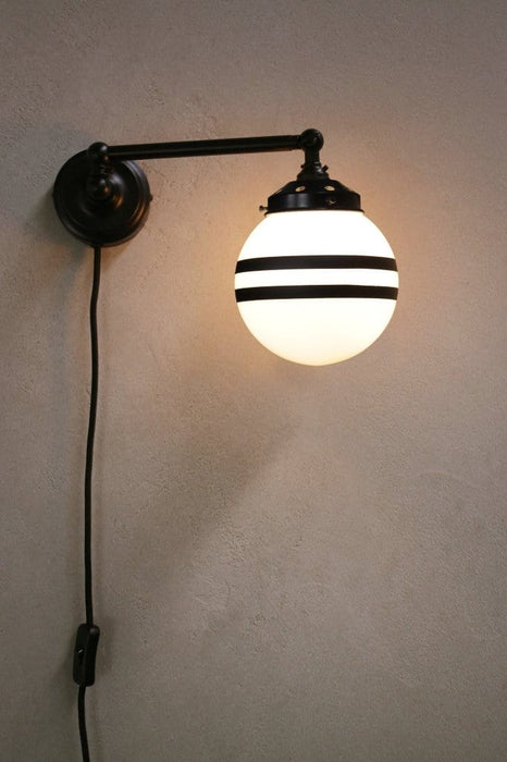 Plug in sconce with small opal two stripe shade