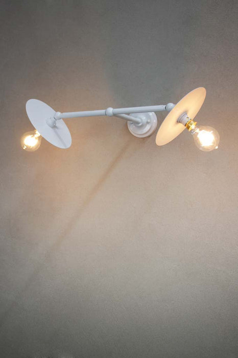 Adjustable white double arm wall light with small white discs
