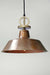 Aged copper pendant light with gold cord and disc