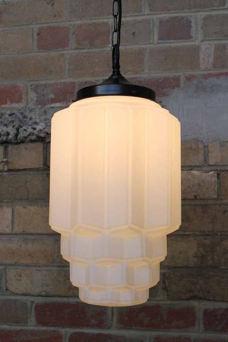Astor pendant light with art deco influence in the opal glass shade and held with chain suspension cord