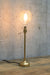 Gold table lamp with ornate bulb
