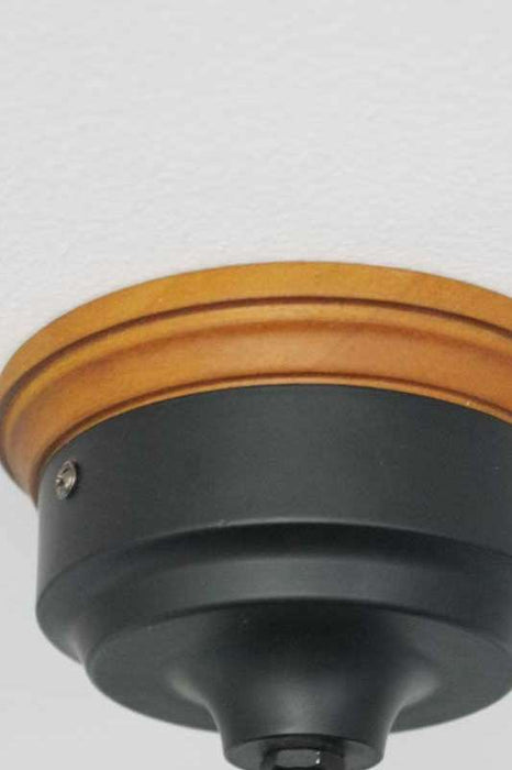 Black sconce with brown mounting block