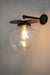 Black disc wall light with clear ball shade