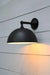 Black dome wall light with straight brass sconce