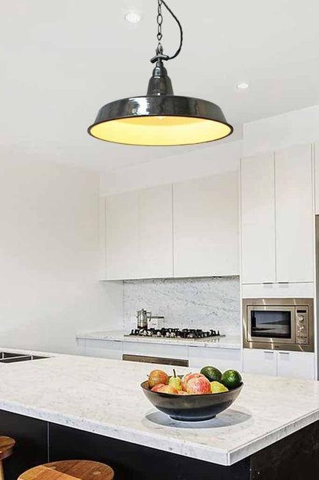 Black enamel pendant in white modern kitchen over kitchen island. Ideal for bedroom lighting or over tables too.