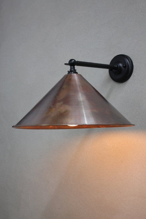 Large aged copper wall light with black steel arm