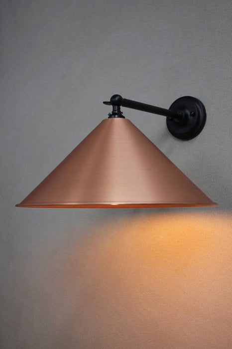 Black steel wall arm with large bright copper shade
