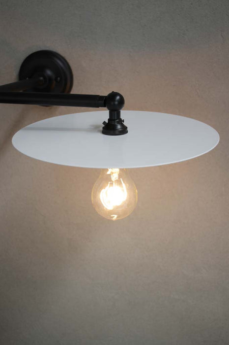 Black wall light with large white disc