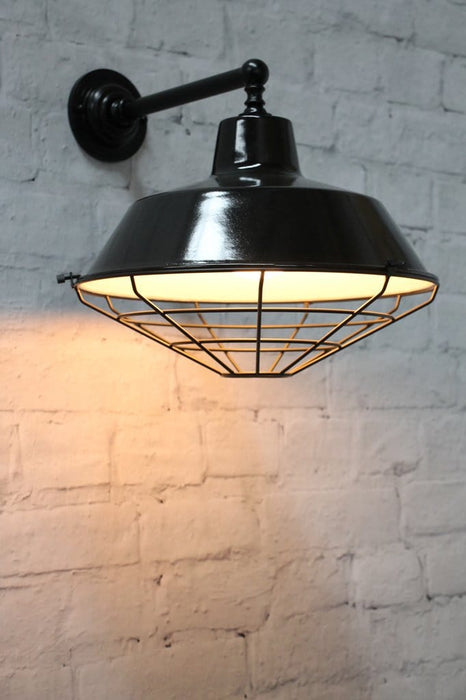 Black wall light with metal shade cage cover
