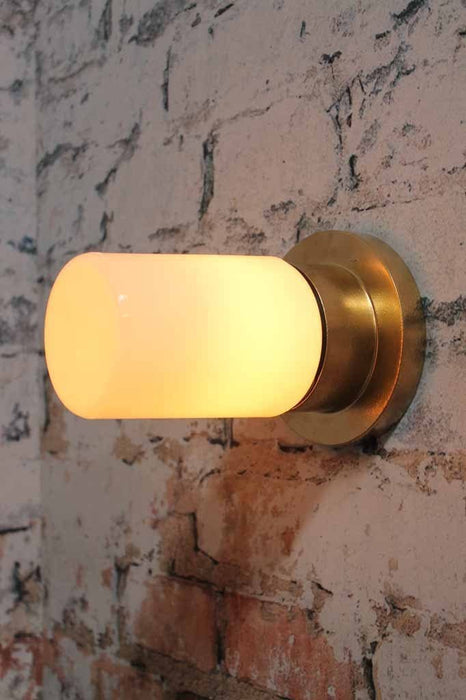 Bunker tube light modern luxe or hollywood regency charm made of metal and finished in a gold paint finish