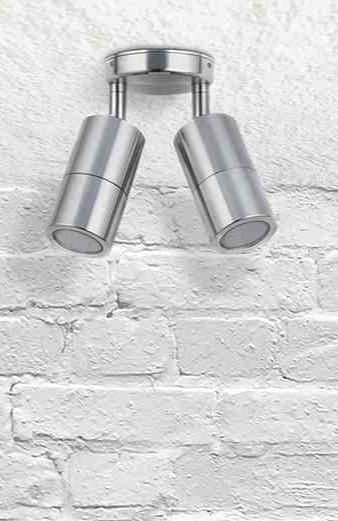 Twinlight spotlight in titanium affixed on a brick wall. 