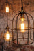 Cage industrial pendant light available in antique brass or black cage shade.