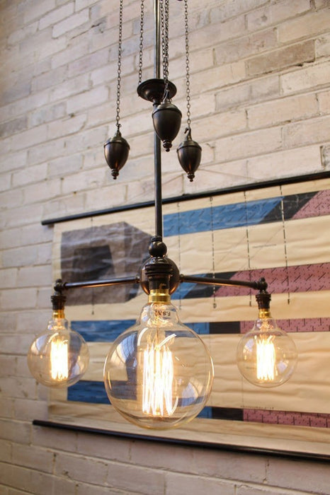 Chandelier pulley light mixes vintage and industrial styles