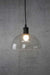 Clear glass outdoor pendant light with small opal bulb