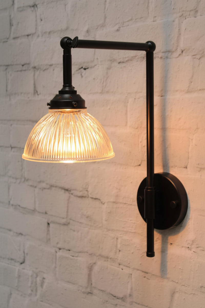 Black wall light with holophane glass shade