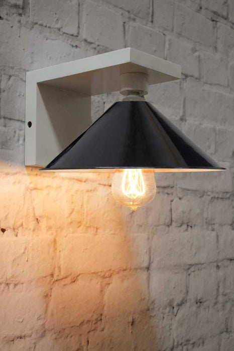 black cone shade with a white wall sconce