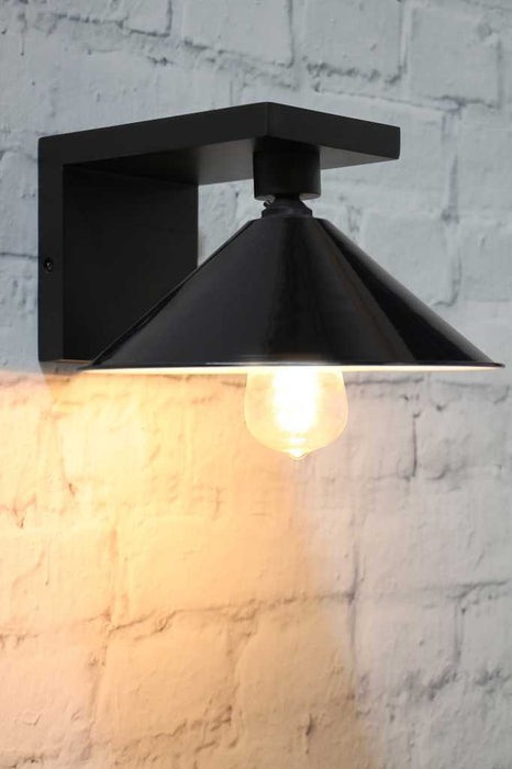 black cone shade with a black wall sconce
