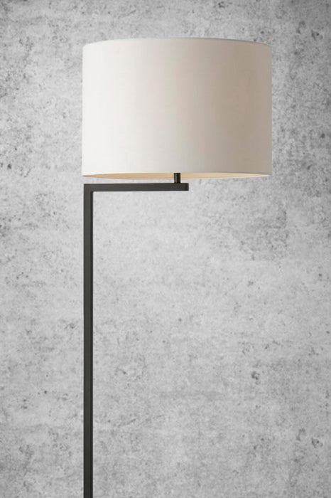 Floor lamp with black stand and white shade