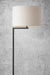 Floor lamp with black stand and white shade