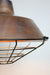 Copper light shade with black cage guard