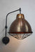 Copper wall light with black cage guard