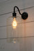 Black gooseneck wall light with cylinder shade