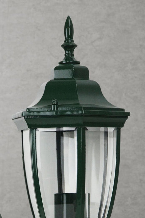 Close-up of outdoor wall light in green finish. 